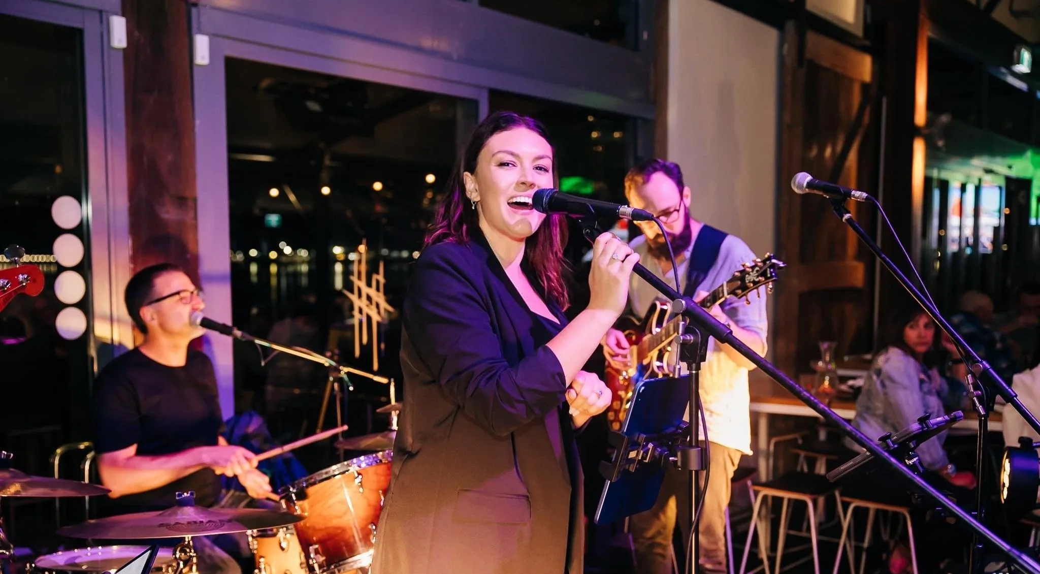 Colour Theory performing live at a hotel function room with guests seated nearby